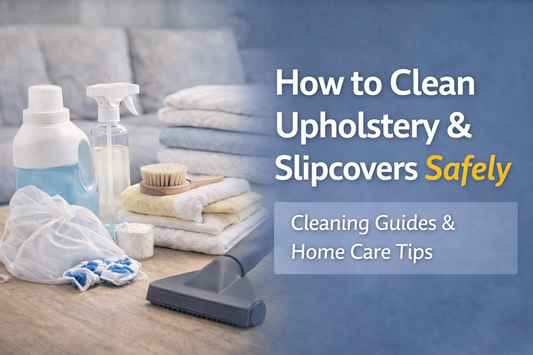 Horizontal thumbnail showing a sofa with a removable slipcover, neatly folded towels, cleaning spray, and a vacuum attachment on a side table, representing safe and organized upholstery cleaning