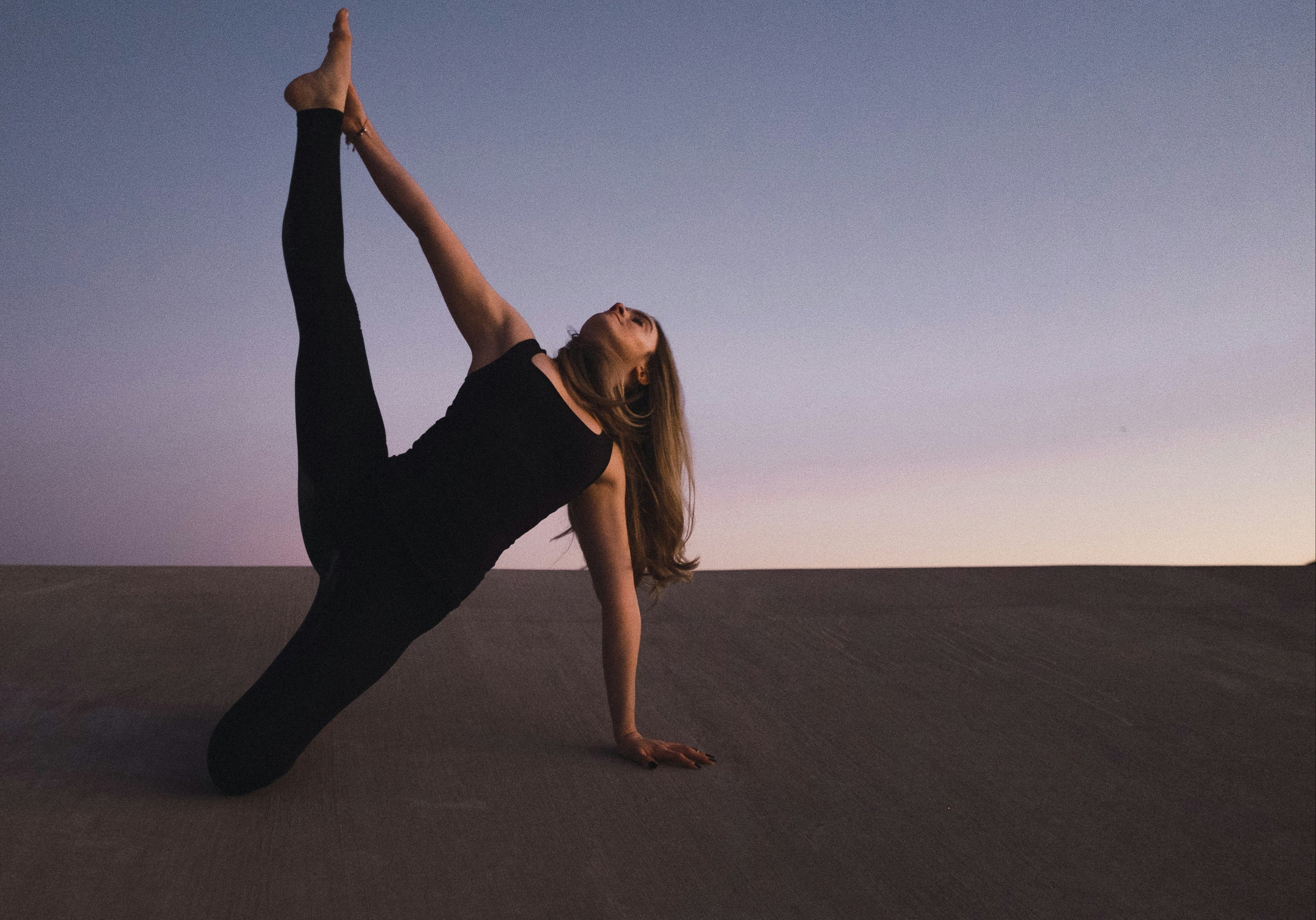 PrimeVita yoga lifestyle hero banner featuring woman practicing balance and flexibility at sunset, symbolizing mindfulness and strength